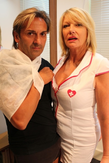 Older blonde nurse has sexual relations with a wounded man on his bed 74116291