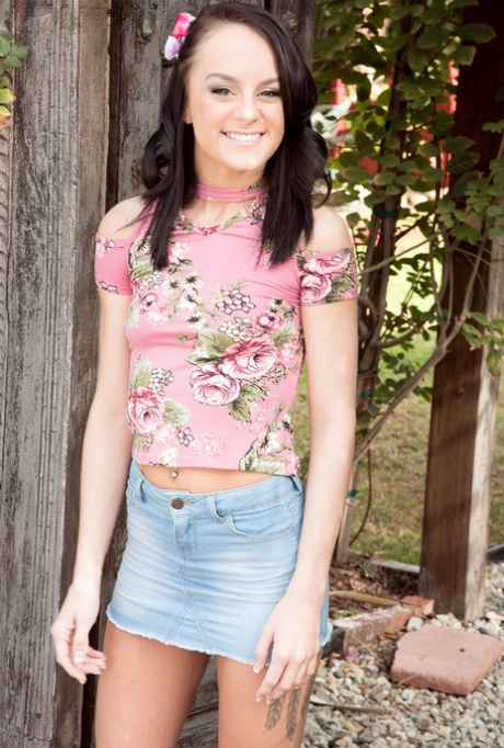 Cute girl Kylie Martin exposes her tiny boobs at a garden gate 18583387