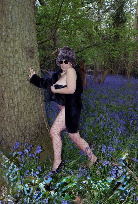 Mature lady removes her winter coat to show her big naturals in mesh pantyhose 18728979