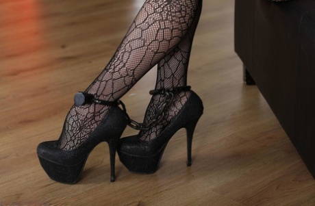Dark haired chick is cuffed at the wrists and ankles while wearing sexy hose 53316684