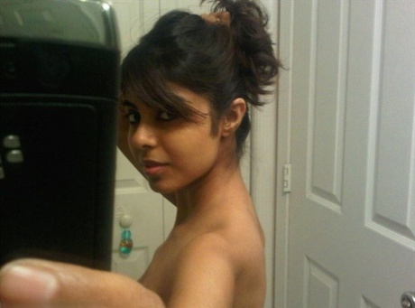 Pretty Indian girl uncovers her nice tits while taking self shots in a mirror 11022601