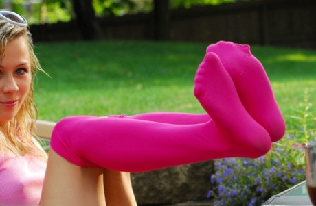 Young blonde Kasia changes over the knee socks while getting naked by a pool 57716094