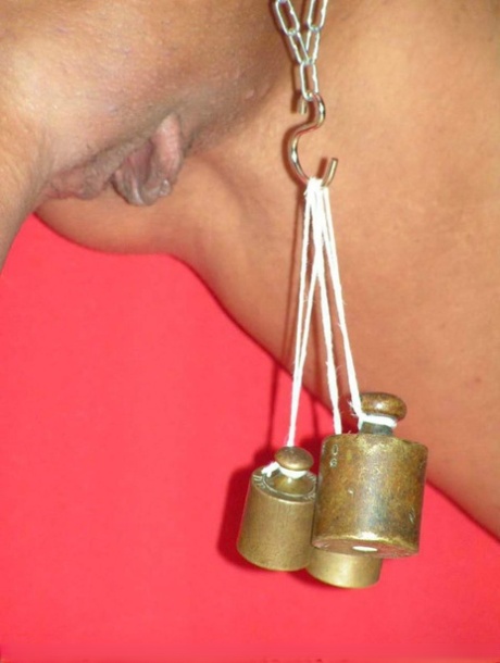 Busty blonde is affixed with clamps while chained to a St Andrew's cross 95379535