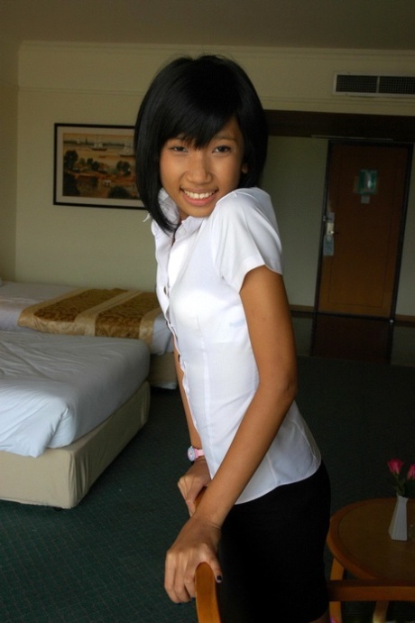 Young Asian girl smokes a cigarette before making her nude modeling debut 12506797