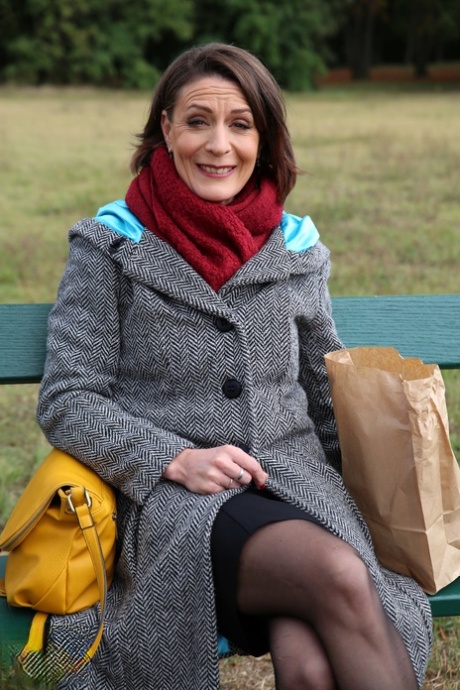 Older woman munches on a loaf on an outdoor bench after getting fucked hard 56125018