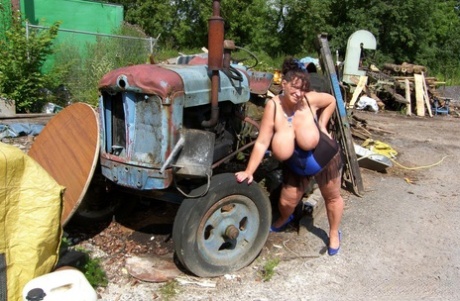 Thick older ladies Busty Kim and April have a threesome amid farm equipment 68901004