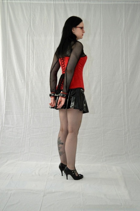 Geeky girl finds herself hogtied in a latex miniskirt and glasses 12063479