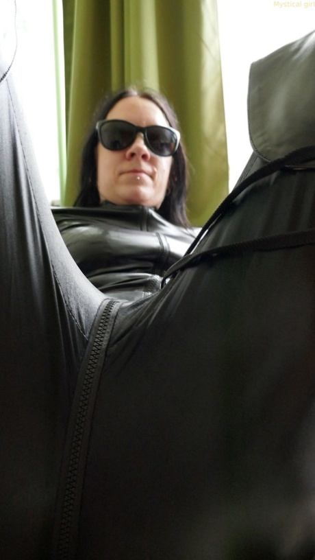 Dark haired amateur models a leather catsuit while wearing dark sunglasses 29759622
