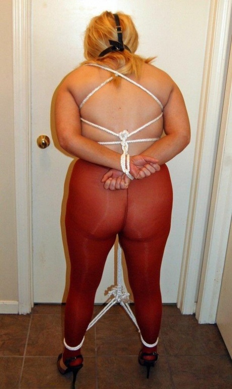 Thick blonde Adrienna has her tits tied up with rope while ball gagged in hose 30521859