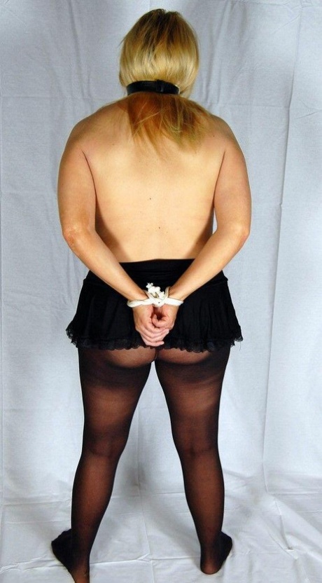 Topless blonde sports a ball gag with her hands tied behind her back in hose 48696057