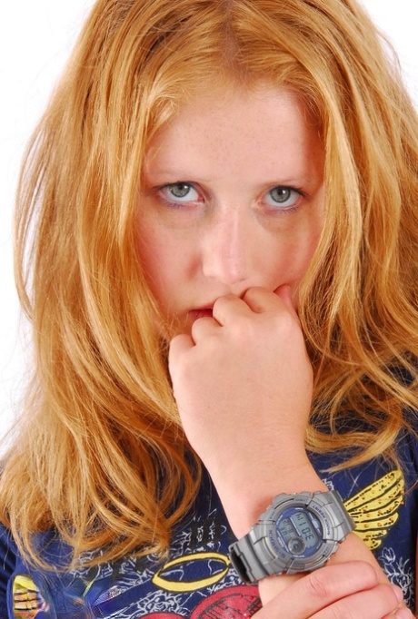 Natural redhead Judy displays her grey G-Shock watch in a T-shirt and jeans 28492474