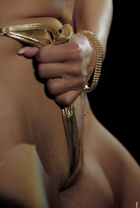 Natural blonde Sharka Blue models a gold bikini in a tempting manner 37596456