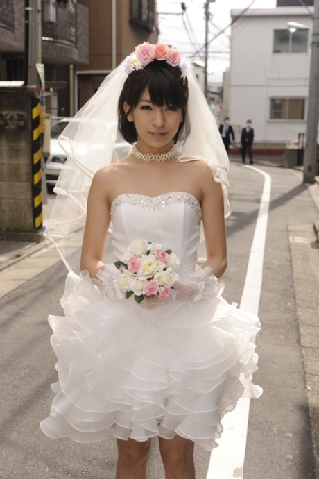 Beautiful Japanese bride Ruri Narumiya poses on the street during her big day 60146335