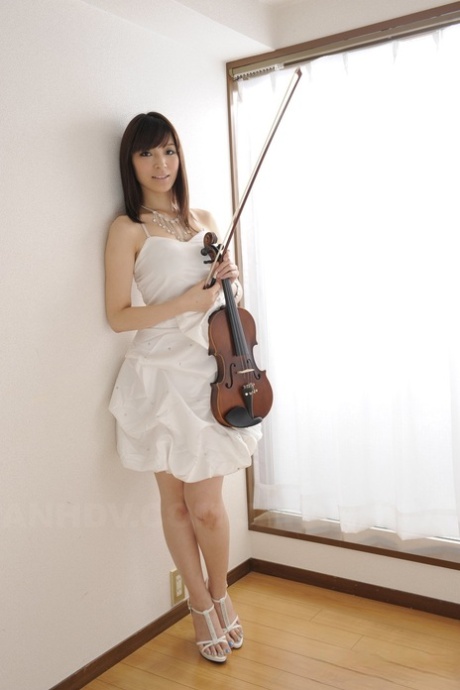 Beautiful Japanese girl Yuria Tominaga gets naked while playing a violin 49406515
