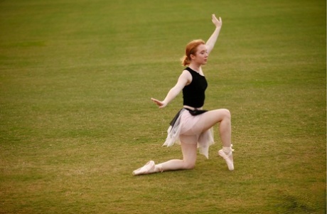 Natural redhead Nicki Blue works on her ballerina moves in an expansive field 54308349